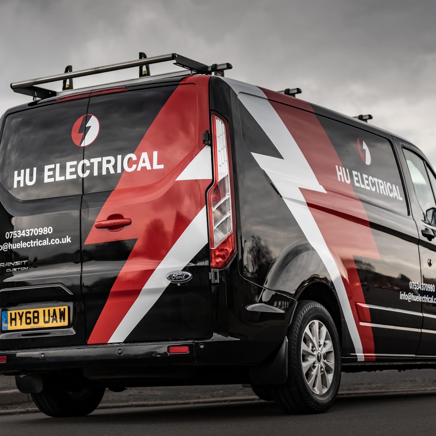 HU Electrical branded work van, showing the red, black and white livery and logo
